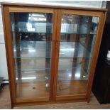 A mirrored display cabinet 20th century. 122cm x 103cm x 39cm.