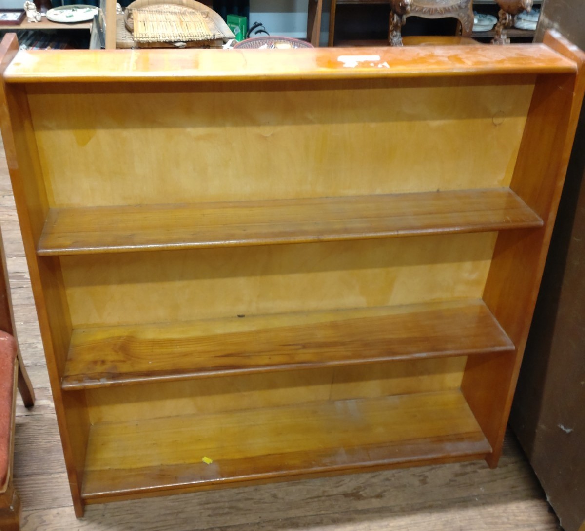 A small bookcase, each shelf gradually larger in depth towards the bottom. Approx. 90cm x 92cm x