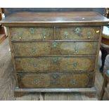 A George I walnut chest of two short and three long graduated drawers.