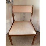 A bedroom chair with a square seat