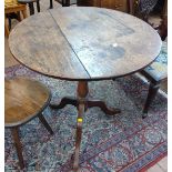 An 18th century oak tripod table. 69 cm x 67cm diameter