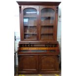 A cylinder Bureau Bookcase, Circa 1840. The upper portion fitted with a pair of glazed door