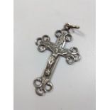 WITHDRAWN A white coloured metal crucifix.