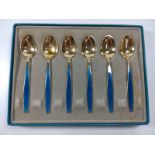 A cased box of gilded enamelled coffee spoons by Georg Jenson. Denmark