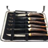 A boxed set of six knives with antler handles.