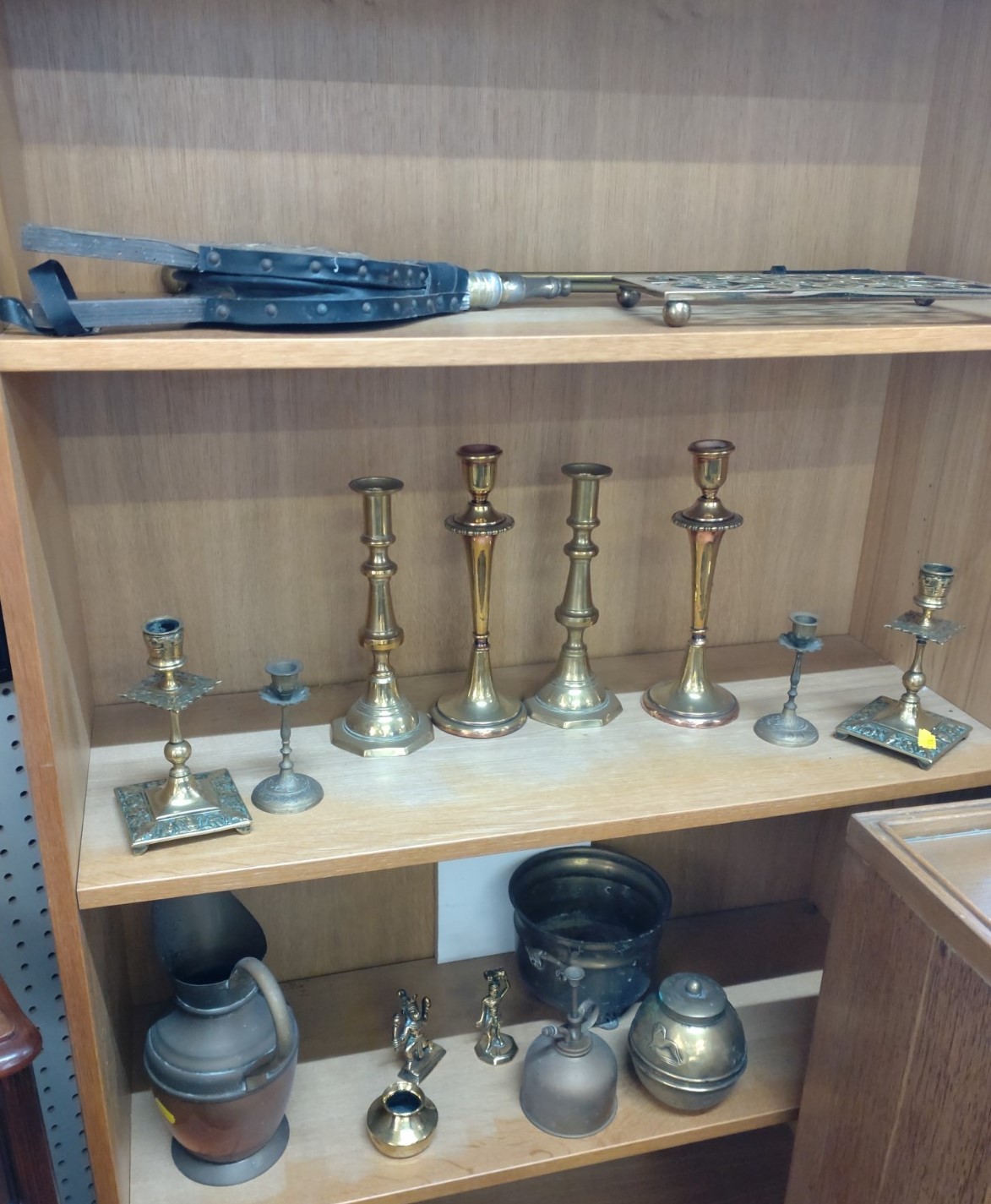 Four pairs of brass candlesticks and eleven other metal wares