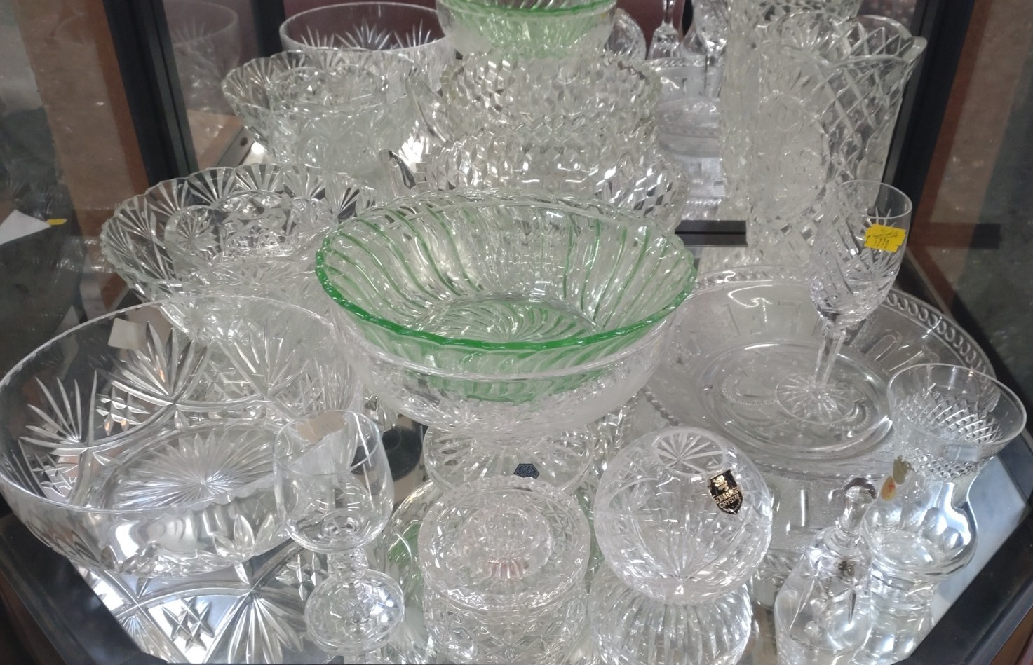 A green glass bowl, clear glass bowls , a salt, a bell, and two glasses. (15)