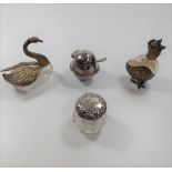A glass and silver metal perfume bottle in the form of a chicken, a glass and white metal swan, a