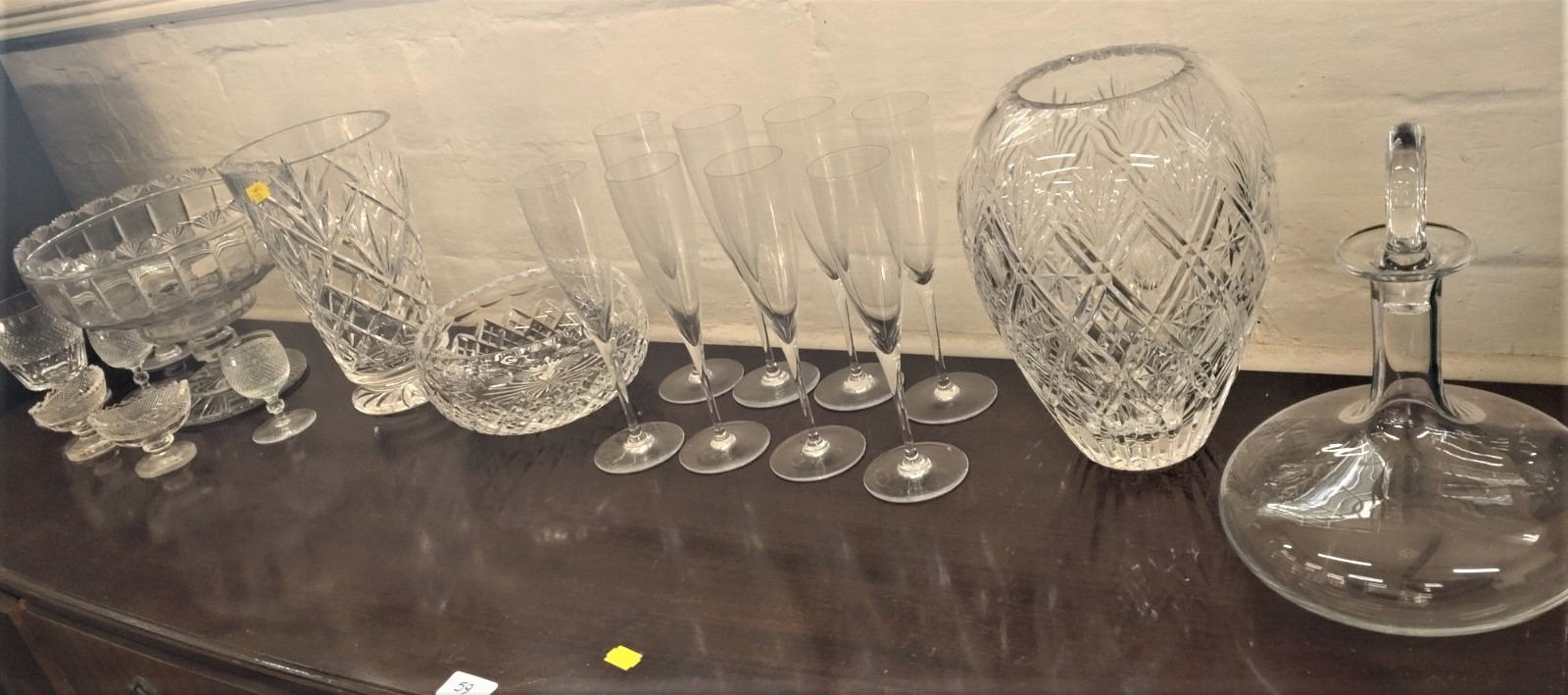 A Baccarat bottle -shaped decanter 26cm, and eight Baccarat Champagne flutes, four cut glasses,