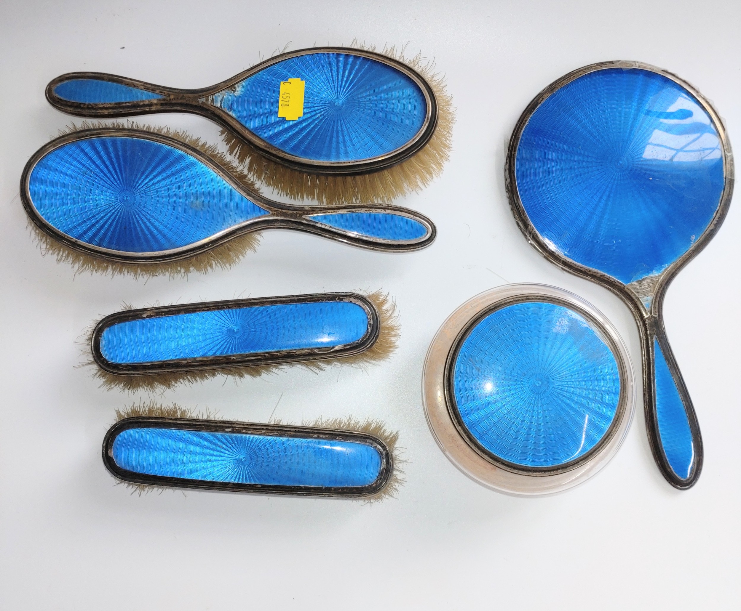 A collection of a lady's silver brush and hand mirror set, decorated in Blue enamel and some