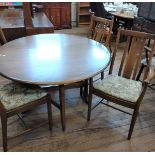 An circular Ercol dining table (both side fold down) and four chairs (one of which is a carver),