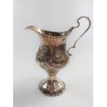 A sterling silver helmet shaped cream jug circa 1780, marks rubbed