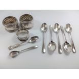 Three continental silver serviette rings and five silver-plate tea spoons, 2 small spoons