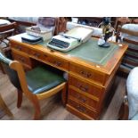 A Kneehole desk 20th century. 76cm x 138cm x 77cm with matching chair.