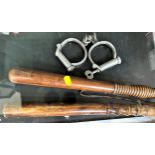 Two Victorian wooden truncheons and a pair of early handcuffs.