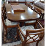 A mahogany extending dining table and chairs (two carvers and four dining chairs). 20th century.