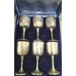 Six silver plated goblets in a case.