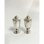 A Pair of George VI Condiments. Of plain vase shaped form. Birmingham 1939. Loaded. 8cm high.