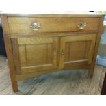 An Oak Cabinet. Circa 1920. Fitted with a single drawer above a pair of cupboard doors. 70cm x