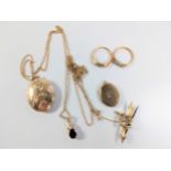 A quantity of 9 carat yellow gold Jewellery. Comprising two lockets, one with chain. A garnet set