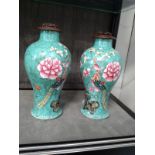 A pair of Chinese famille-rose decorated with paeonies and phoenix on a turquoise ground 24cm,