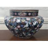 A cloisonne jardiniere decorated with cranes and flowers on black ground 38.5cm diameter, 26cm high