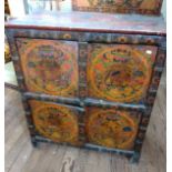 A Chinese or Tibetan cabinet. Decorated with panels of Chinese motifs including Demons. Bamboo