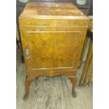 A Walnut veneered bedside cabinet, fitted with a single door. 70cm x 38cm x 38cm