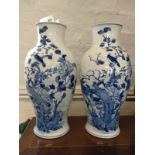 A pair of Chinese blue and white vases 43.5cm one with a crack to the base and rivet and plaster