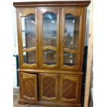 A 20th Century. Display cabinet. The upper case with a pair of doors enclosing glass shelves,