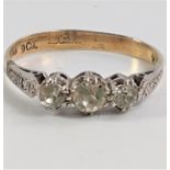 A three-stone ring, two diamonds, one probably a white sapphire. size N 1.79g.