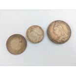 Three Victorian silver coins. Including a crown and a half crown.