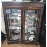 A display cabinet with two glass shelves (contents not included)
