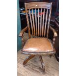 A 20th century Captain's Chair. With leather over stuffed seat.
