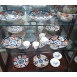 Six Imari plates and a bowl; a green bowl (repaired) and Regency china cups and saucers (flour