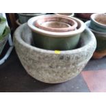 Four concrete garden pots