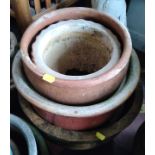 Four concrete garden pots