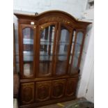 A large display cabinet. 20th century. With a pair of doors enclosing glass shelves. 210cm x 144cm x
