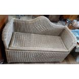 A wicker storage bench. 68cm x 95cm x 43cm.