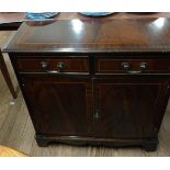 A Modern Mahogany reproduction two-door cabinet fitted with a single drawer. 20th century.