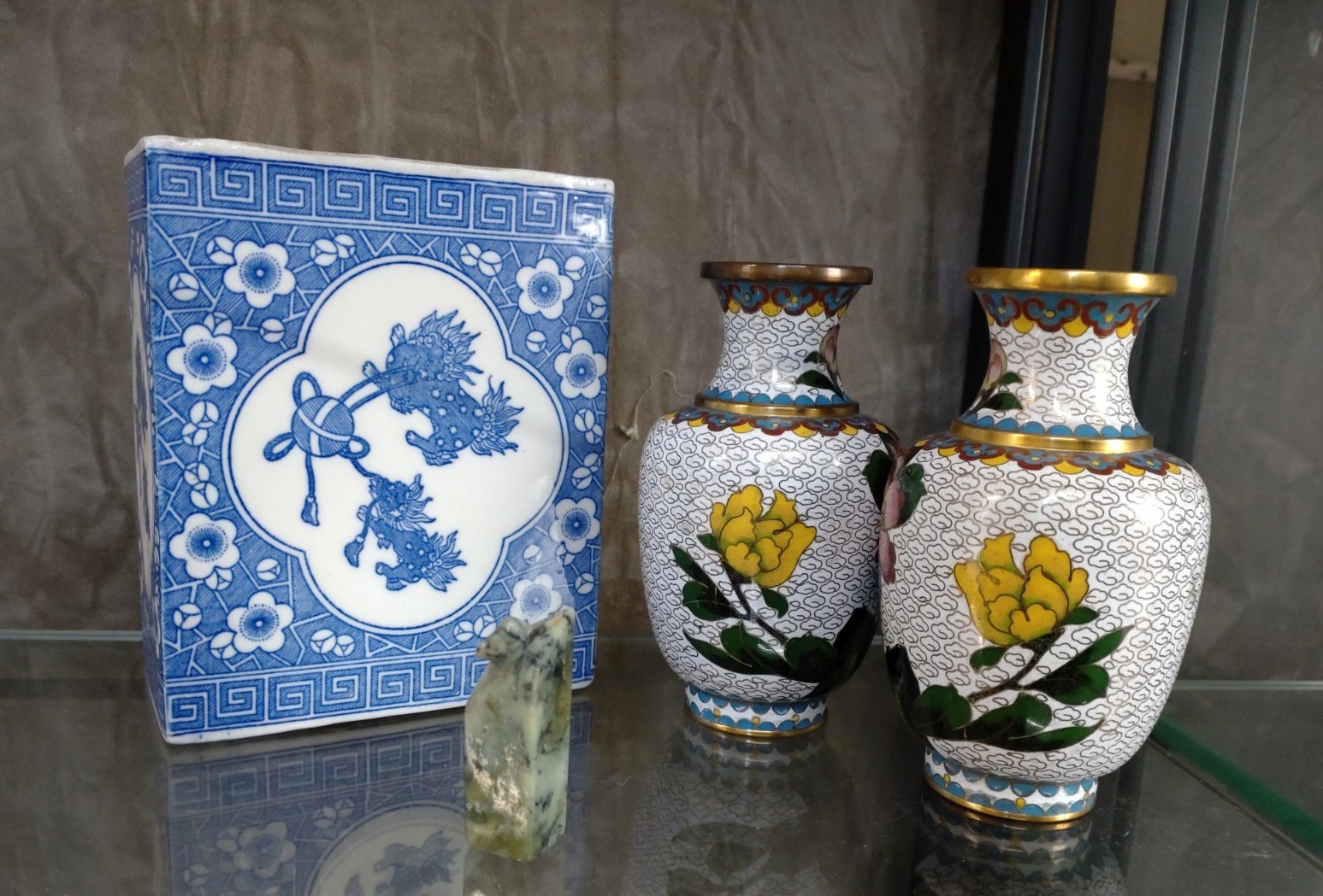 A pair of Cloisonne white ground vases, blue and white posy-holder and a Nephrite seal choc.