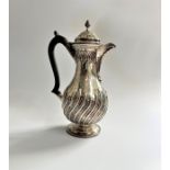 Nathan and Hayes. A Sterling silver hot water jug. Birmingham 1888. The baluster body part chased