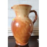 A large pottery jug with rope-twist handle 36cm