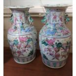 A pair of Chinese Canton famille-rose vases decorated with panels of warriors, 36cm, one with glue