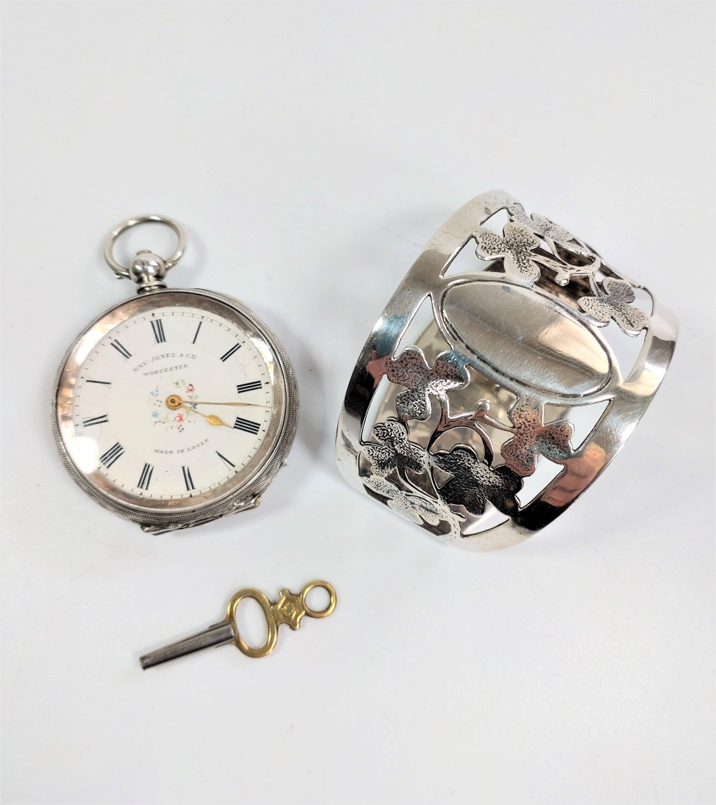 A swiss Fob watch, late 19th century, with a key and a sterling silver napkin ring.