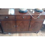 A Mahogany Sideboard. 20th century. Fitted with three drawers over three cupboard doors. 86cm x