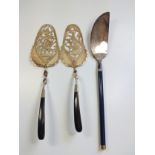 A pair of fret cut Oriental design gilded pastry servers and a French cheese/ pastry server.