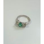 Certificated 18ct white gold emerald and diamond trilogy ring.