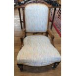 A walnut Victorian nursing chair with porcelain casters. Circa 1870. Reupholstered.