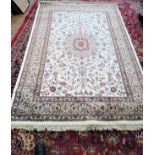 An ivory ground full pile Kashmir rug with a Sharbass lozenge medallion design (230cm x 160cm)